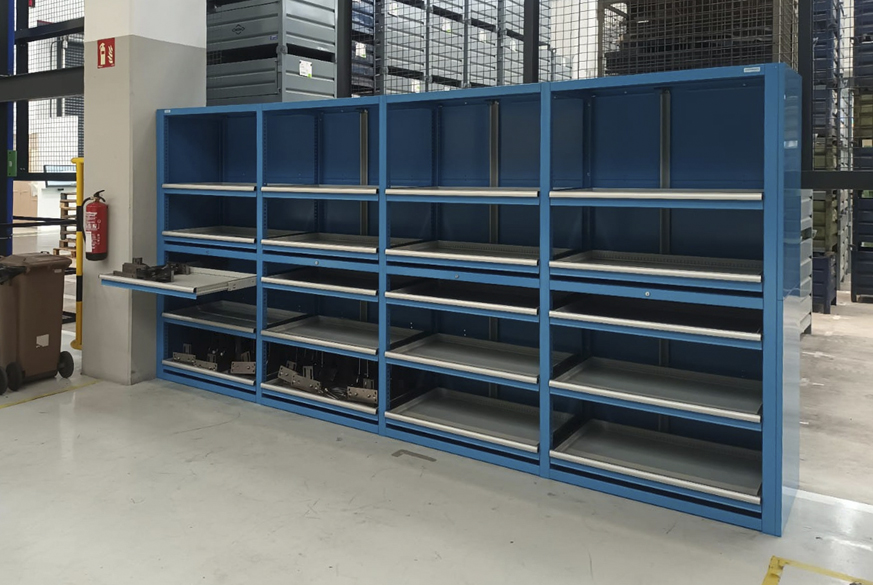 Diseño a medida, transporte y montaje de un sistema de almacenamiento compuesto por una batería de estantería metálica modular con cerramientos y bandejas extraíbles. Todo ello montado en departamento de matricería de empresa de estampaciones para sector automoción